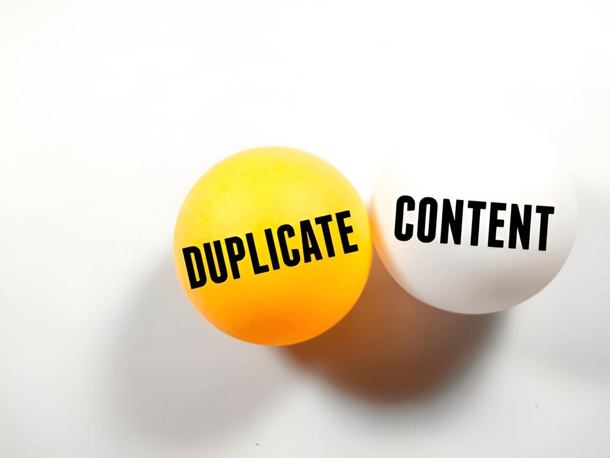 Two balls labeled 'Duplicate' and 'Content,' symbolizing duplicate content in SEO